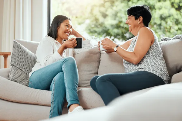 mother and daughter talking on the sofa