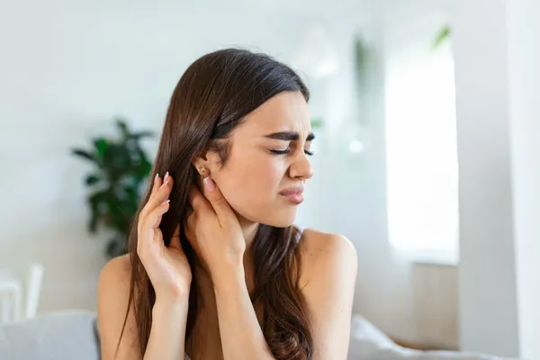 woman suffering from tinnitus