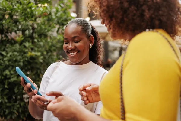 two black women looking at reproductive health information together